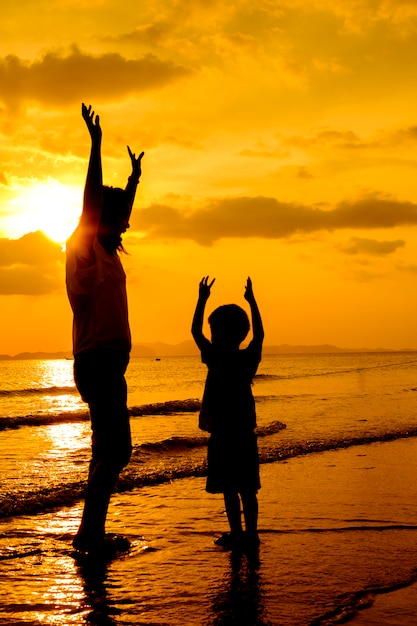 Free photo a mother and son in outdoors at sunset with copy space