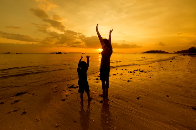 A mother and son in outdoors at sunset with copy space