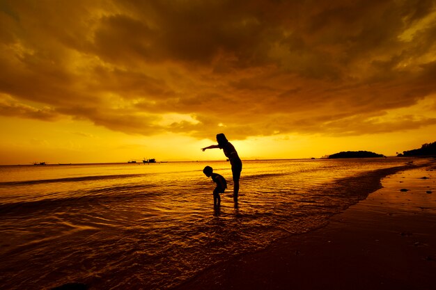 A mother and son in outdoors at sunset with copy space