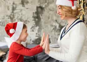 Free photo mother and son playing on christmas