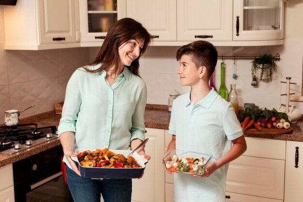 Mother and son preparing food in the kichen