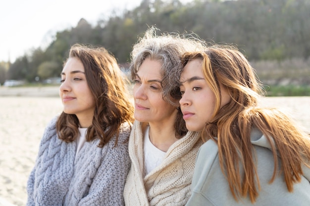 Free photo mother spending time at the beach with her two daughters