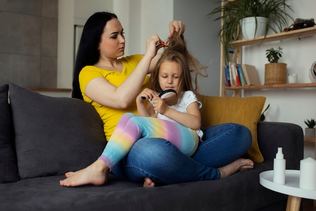 Mother taking care of child with head lices