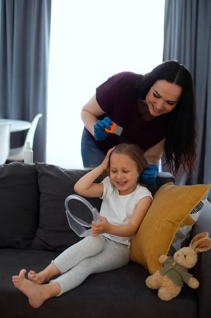 Mother taking care of child with head lices