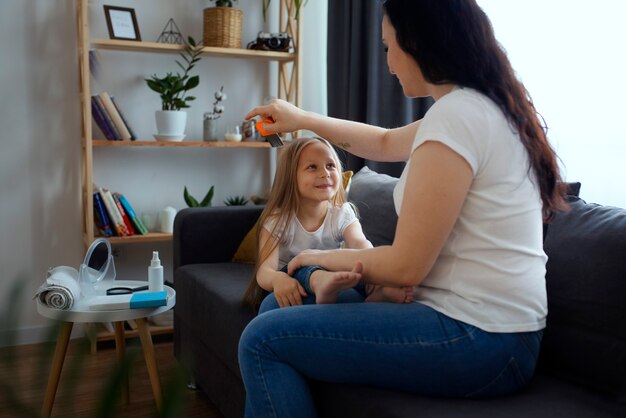 Mother taking care of child with head lices