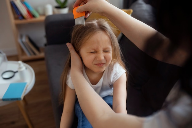 Mother taking care of child with head lices