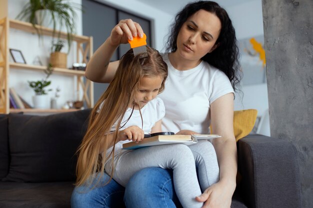 Mother taking care of child with head lices