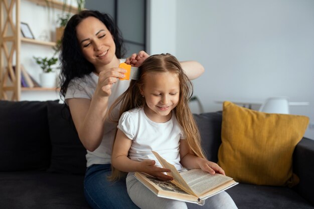 Mother taking care of child with head lices