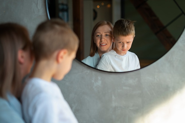 Free photo mother taking care of her autistic son at home