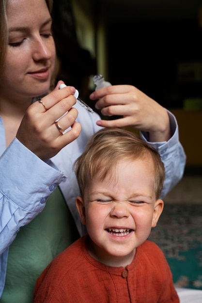 Mother taking care of her kid with lices