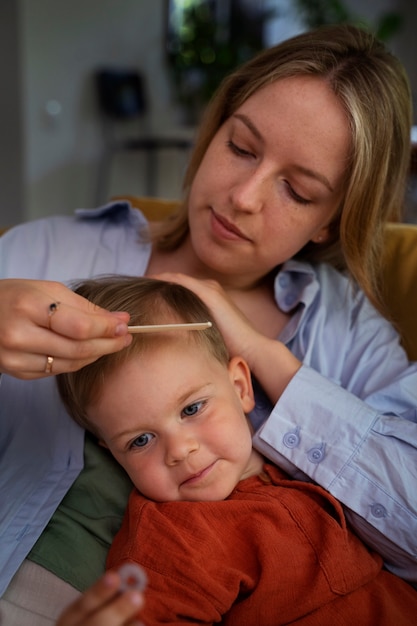 Mother taking care of her kid with lices