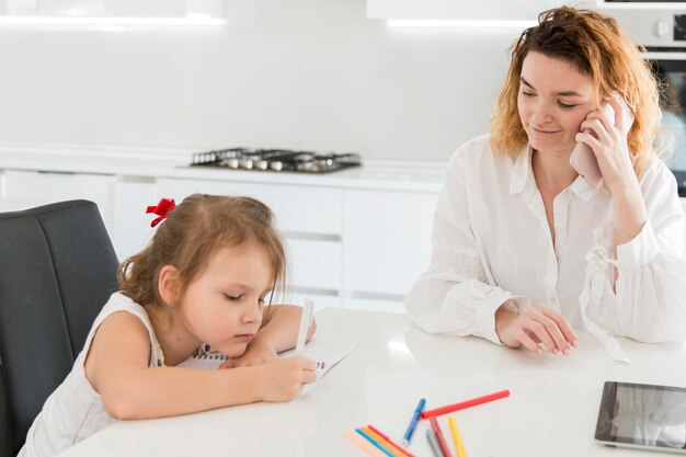 Mother talking on phone at home