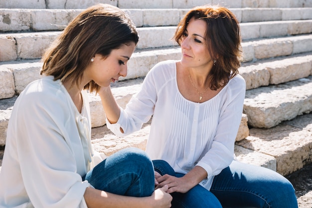 Free photo mother touching face of woman