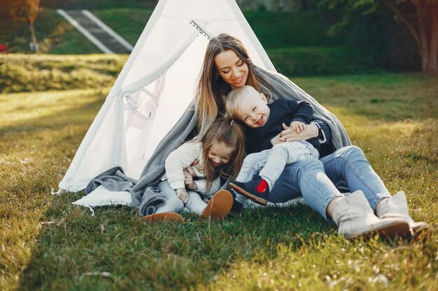 Mother with children playing in a summer park