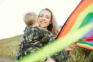 Free photo mother with cute little son in a summer field