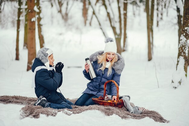 Mother with cute son in a winter oark