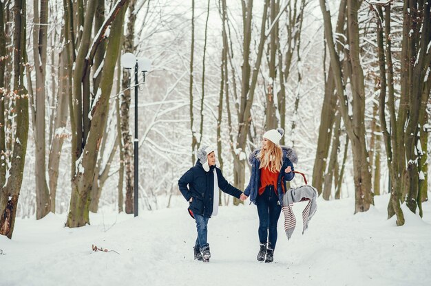 Mother with cute son in a winter oark