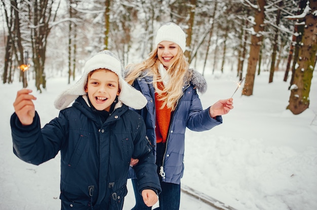 Free Photo mother with cute son in a winter oark