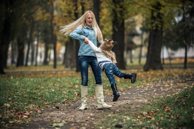 Mother with daughter in autumn park