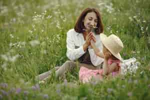 Free photo mother with daughter playing in a summer field