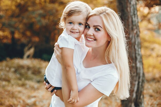 Mother with daughter playing in a summer park