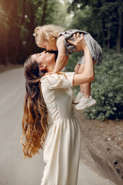 Mother with daughter playing in a summer park