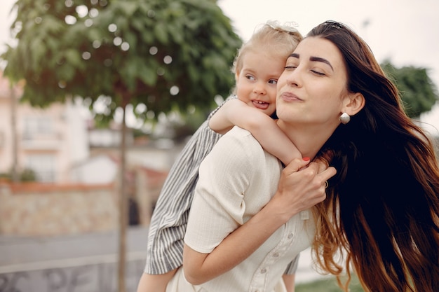 Mother with daughter playing in a summer park