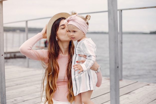 Mother with daughter playing in a summer park