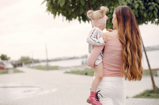 Mother with daughter playing in a summer park