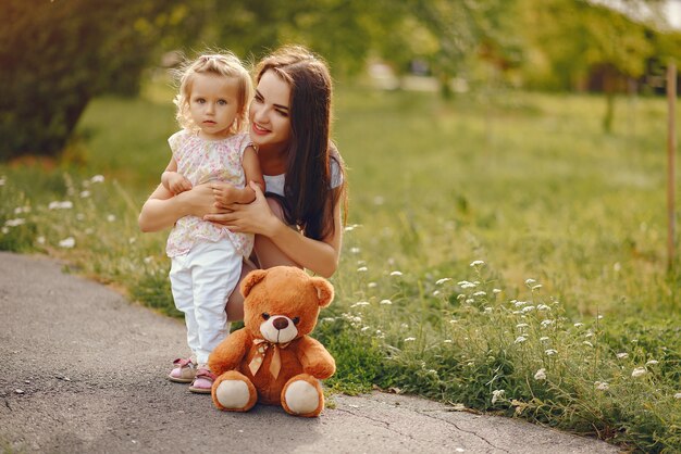 Mother with daughter playing in a summer park