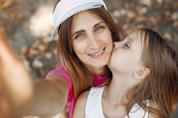 Mother with daughter playing in a summer park