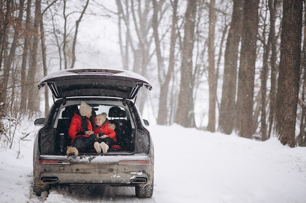 Free photo mother with daughter sitting in car in winter