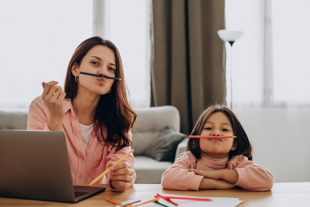 Mother with daughter studying at home