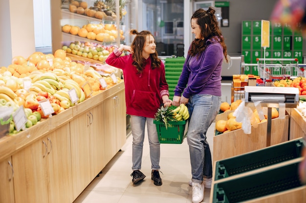 Mother with a daughter in a supermarket