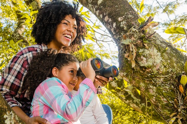 Mother with daughter next to a tree