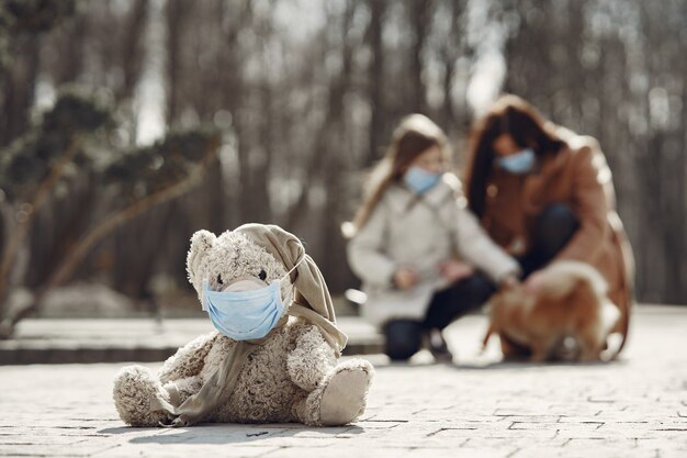 Mother with daughter walks outside in masks