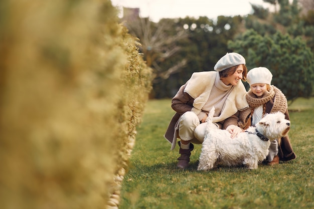 Mother with daughter walks with a dog