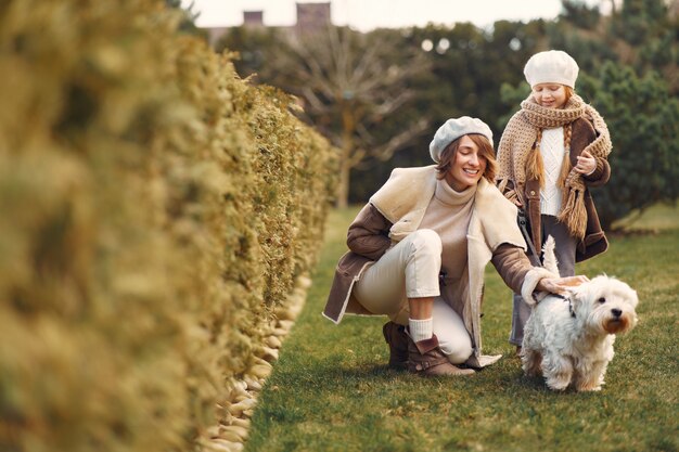 Mother with daughter walks with a dog