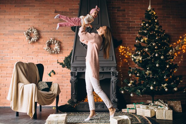 Mother with daughterby the fireplace on Christmas