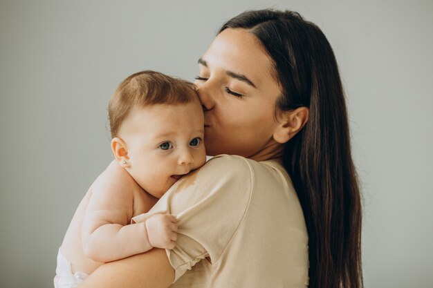 Mother with her baby girl at home