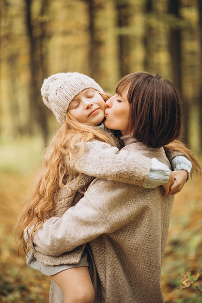 Mother with her daughter in park having fun