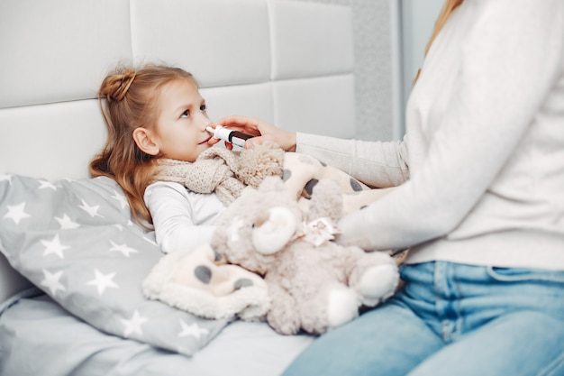 Mother with her illnes daughter in a bedroom