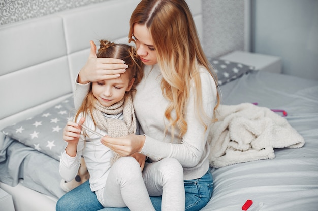 Mother with her illnes daughter in a bedroom