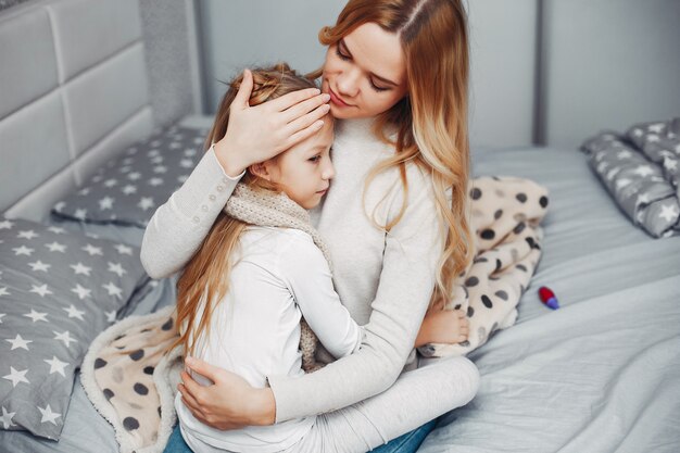 Mother with her illnes daughter in a bedroom