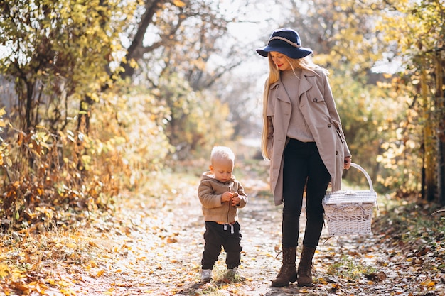 Mother with her little son in autumn park