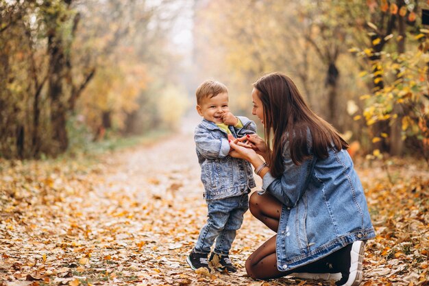 Mother with her little son in autumn park