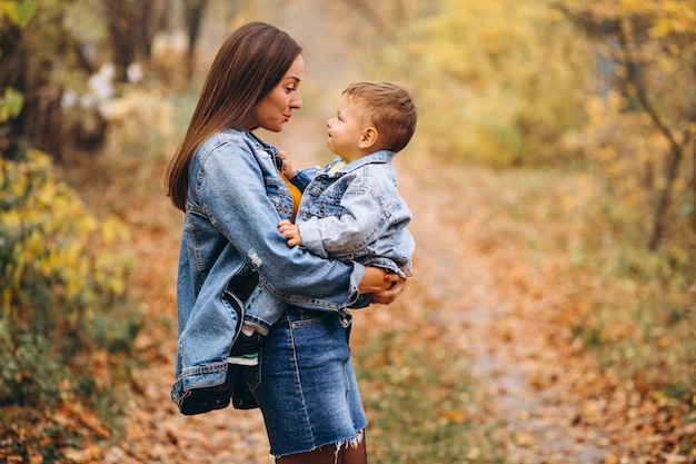 Mother with her little son in autumn park