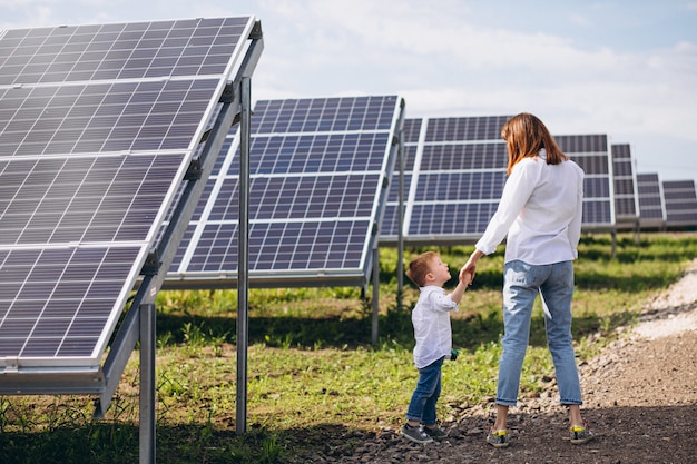 Mother with her little son by solar panels