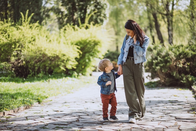 Mother with her little son having fun in park