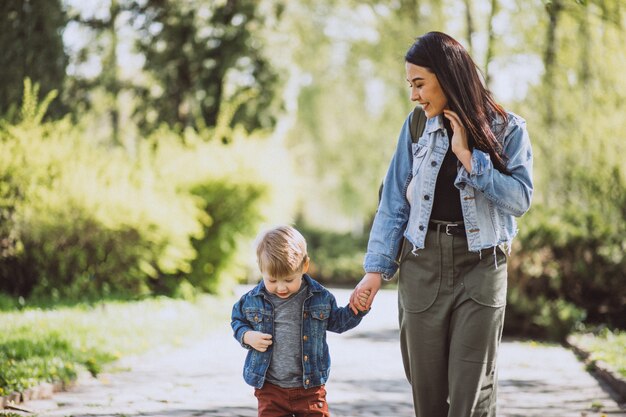 Mother with her little son having fun in park